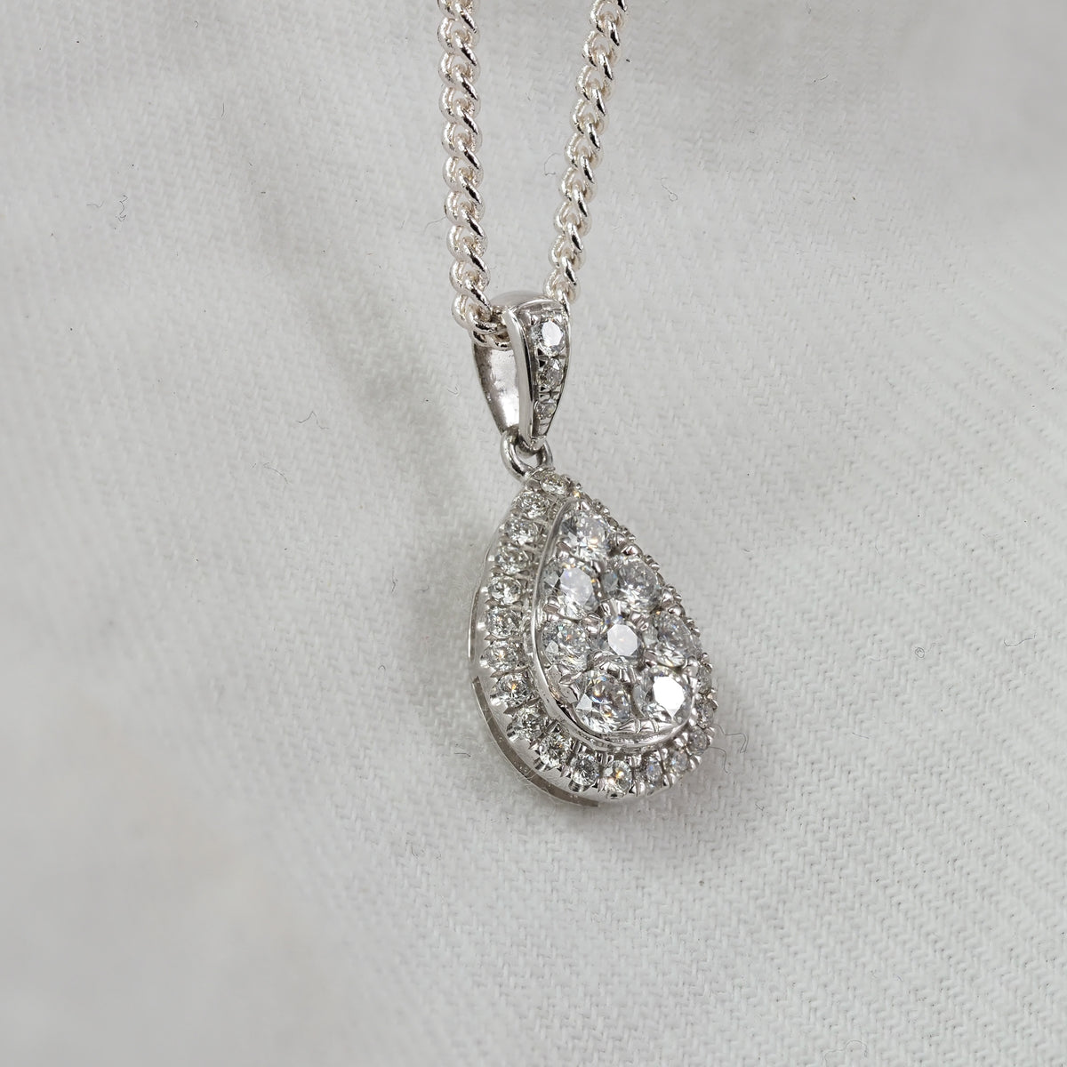 9ct White Gold Pear Shaped cluster Diamond pendant, equaling 0.52ct