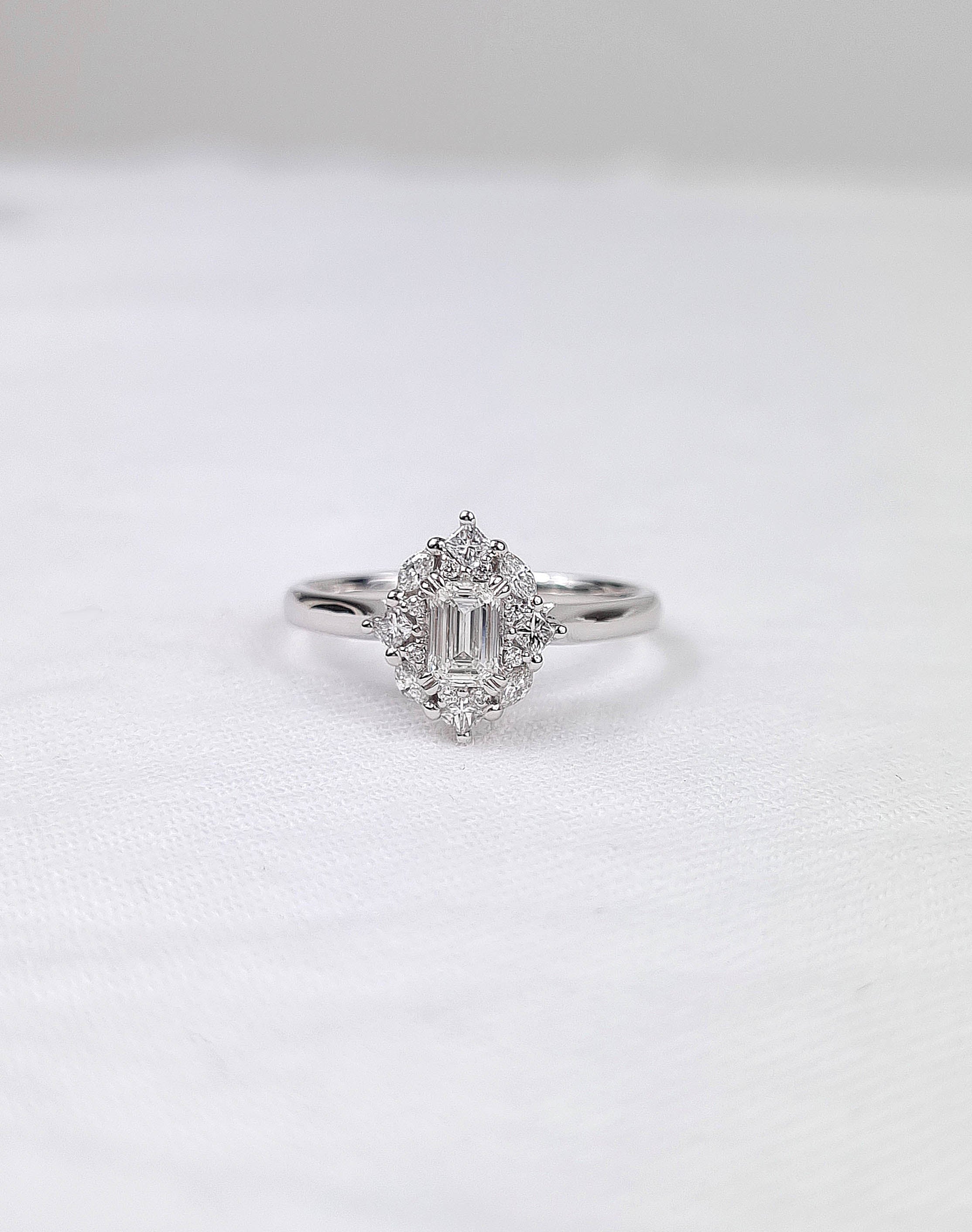 18ct Gold Emerald Cut Halo Diamond Ring, 0.61 carats.