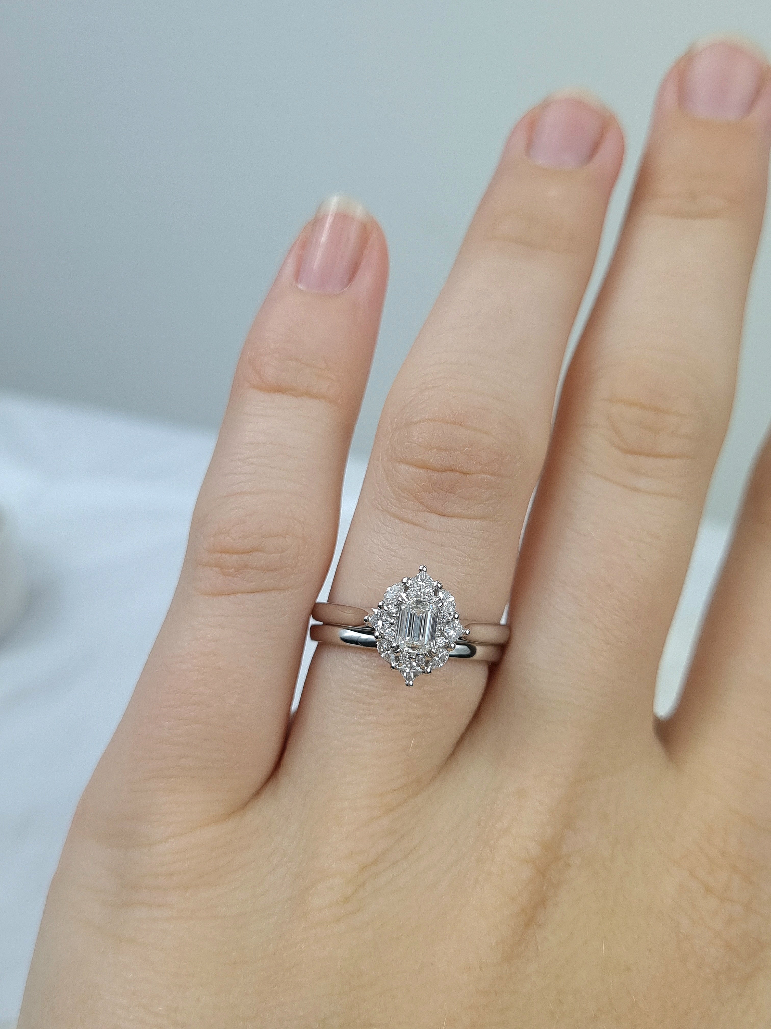 18ct Gold Emerald Cut Halo Diamond Ring, 0.61 carats.