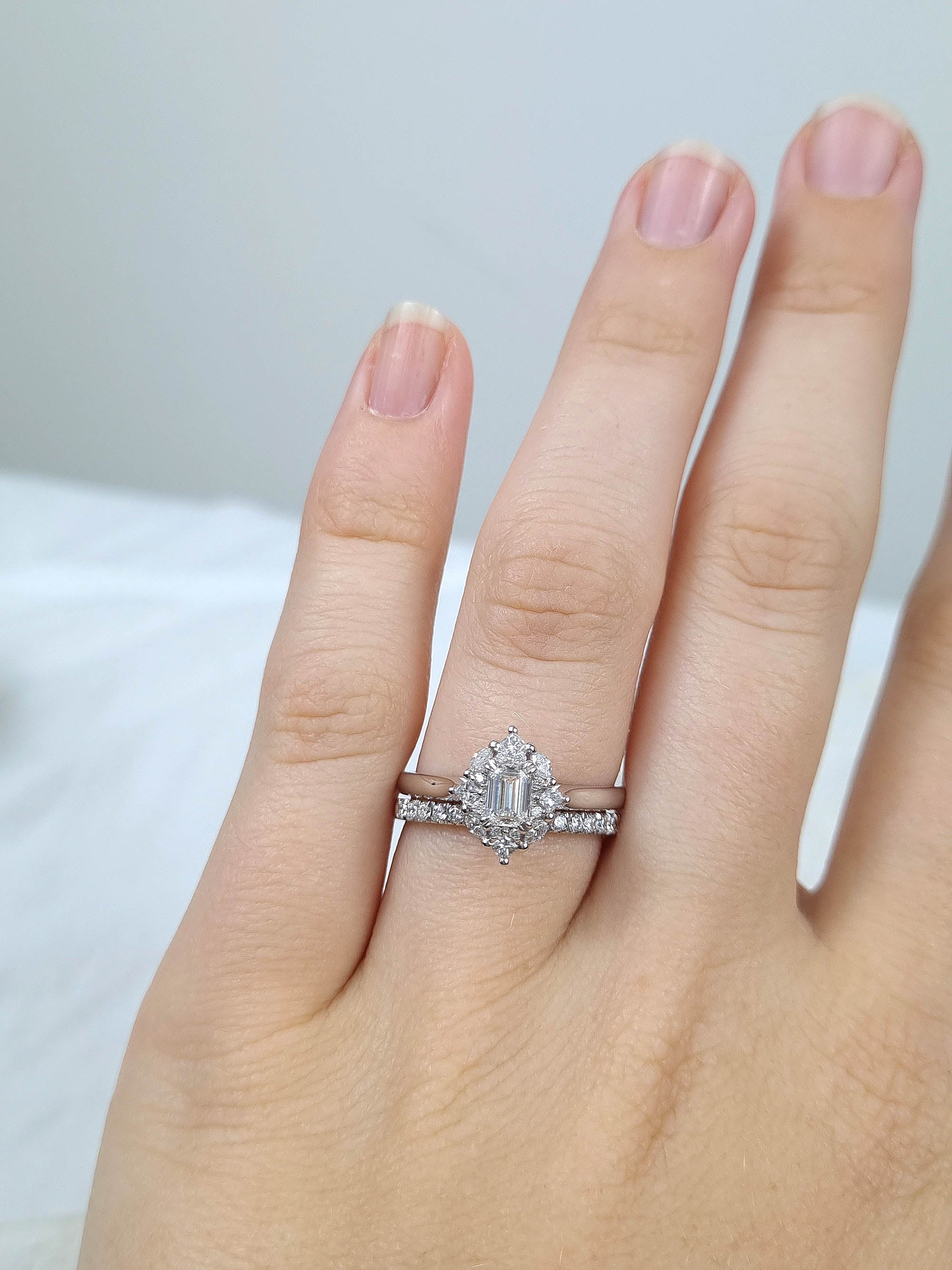 18ct Gold Emerald Cut Halo Diamond Ring, 0.61 carats.