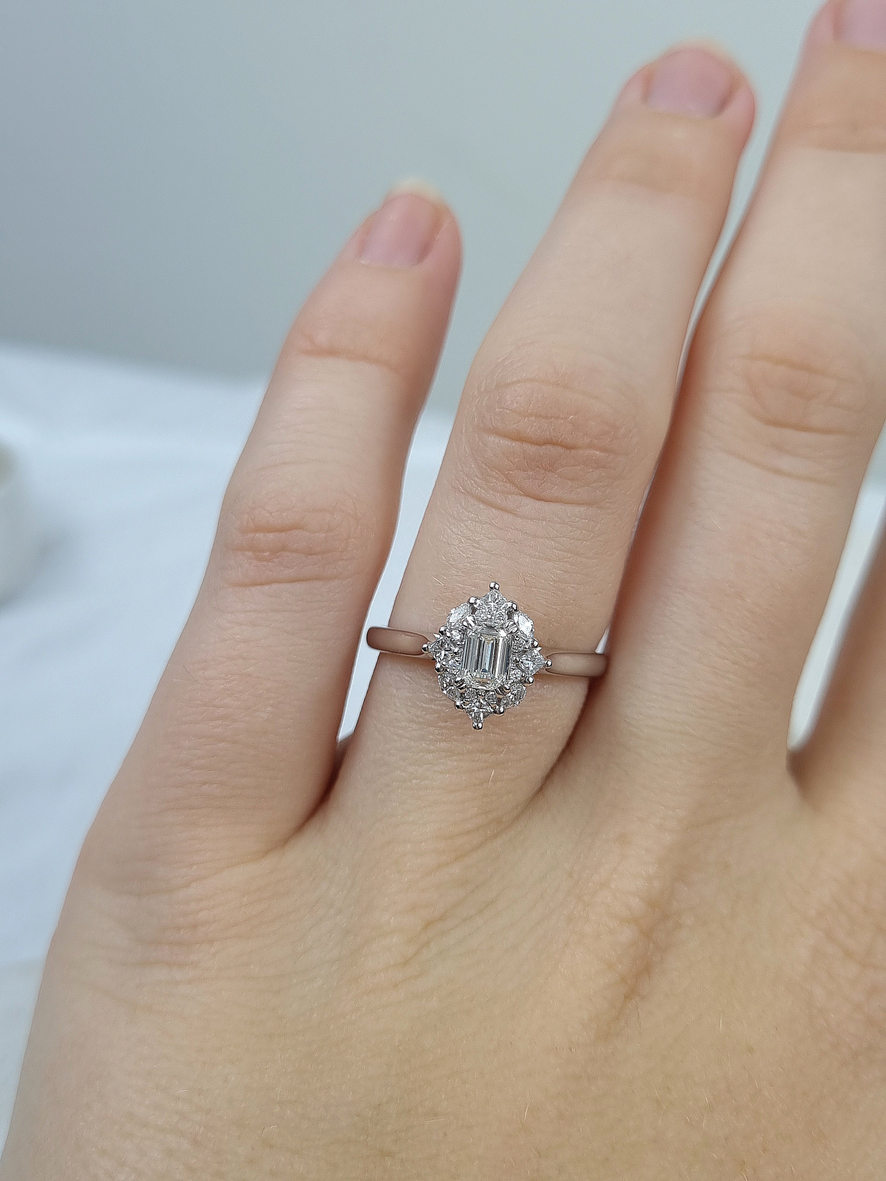 18ct Gold Emerald Cut Halo Diamond Ring, 0.61 carats.