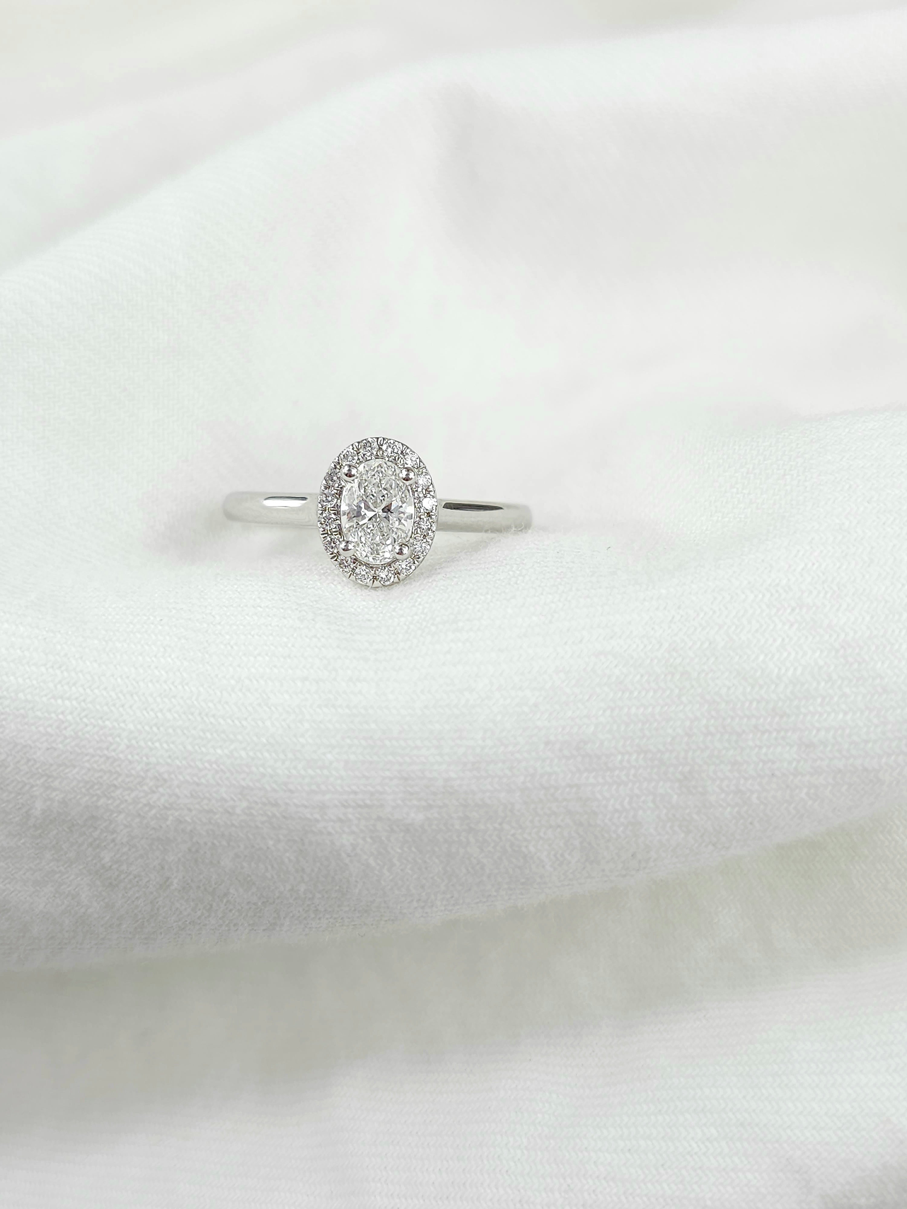 18ct White Gold Oval Halo Ring, 0.50 carat centre.
