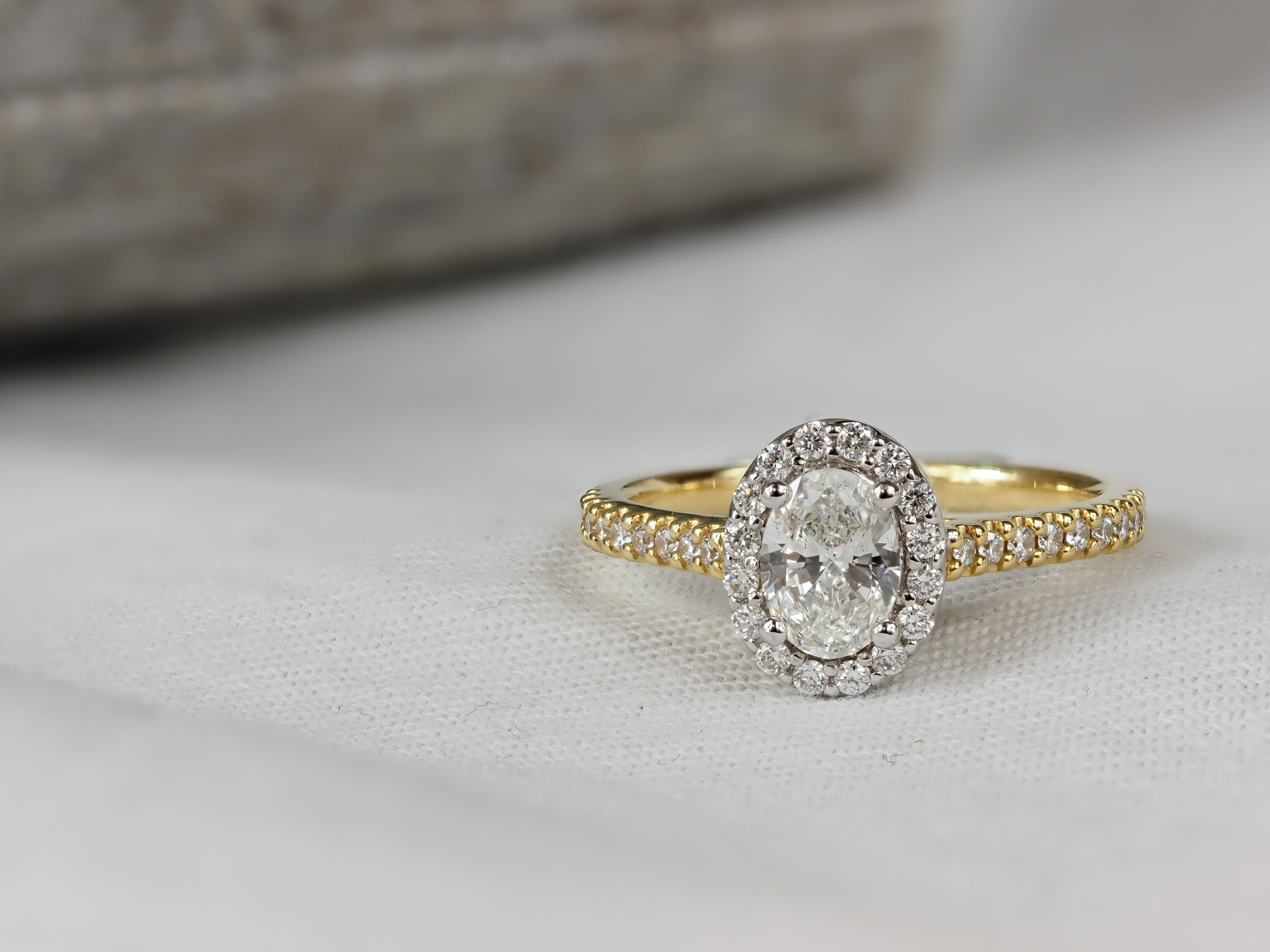 18ct Yellow and White Gold Oval Halo Engagement Ring, 0.56ct centre
