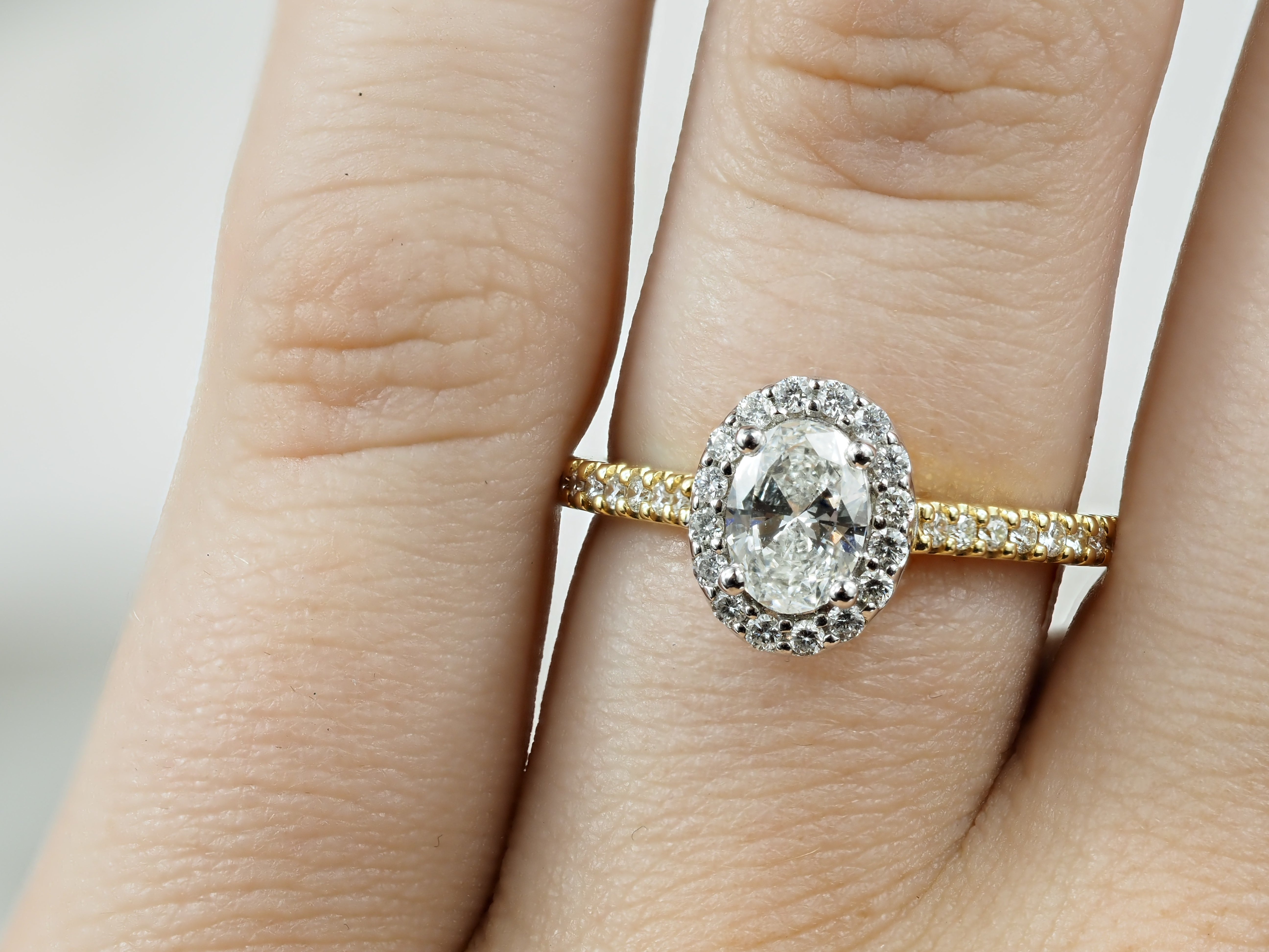 18ct Yellow and White Gold Oval Halo Engagement Ring, 0.56ct centre