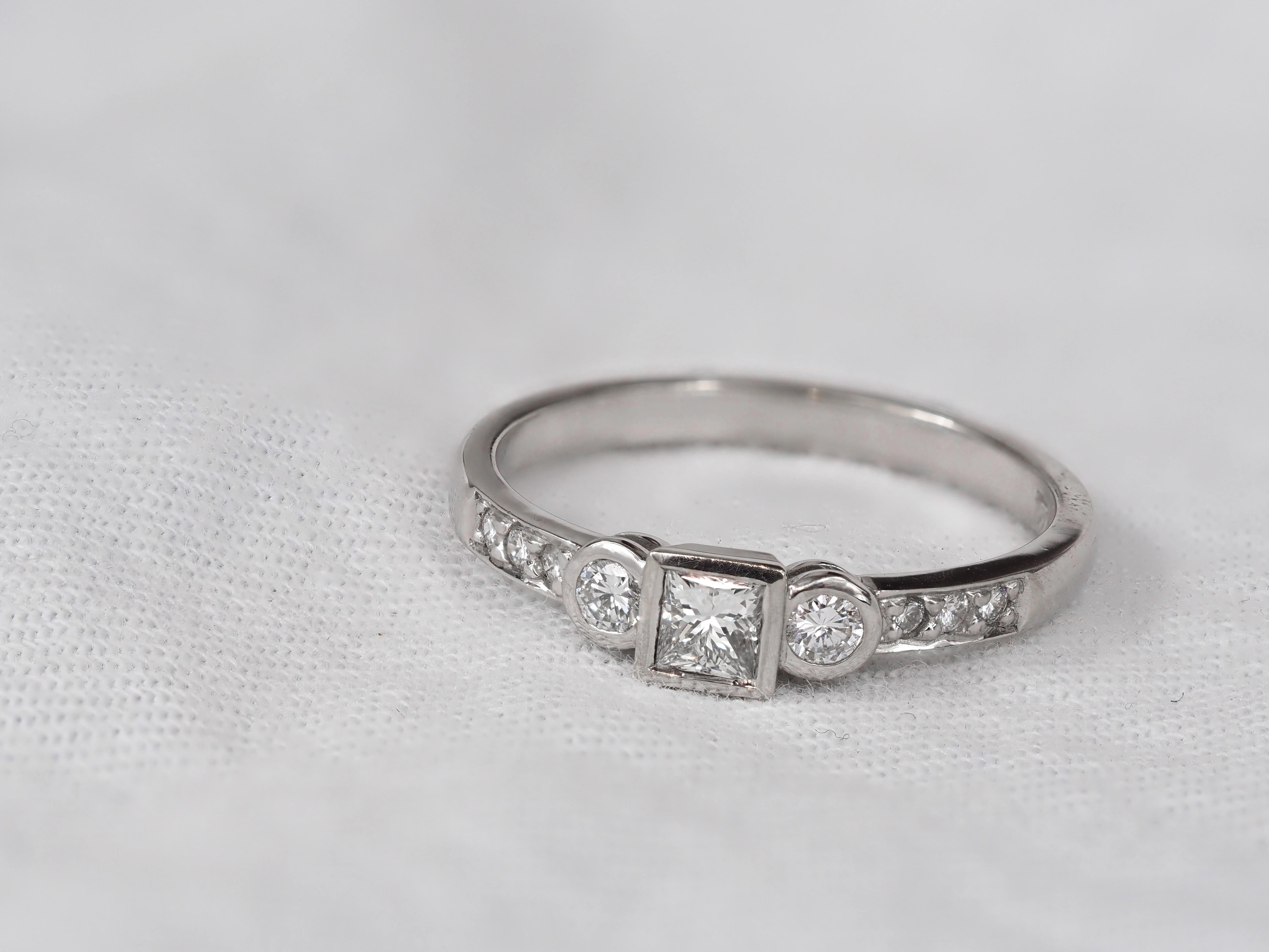 18ct White Gold Princess and Round Brillant cut Diamond Engagement Ring