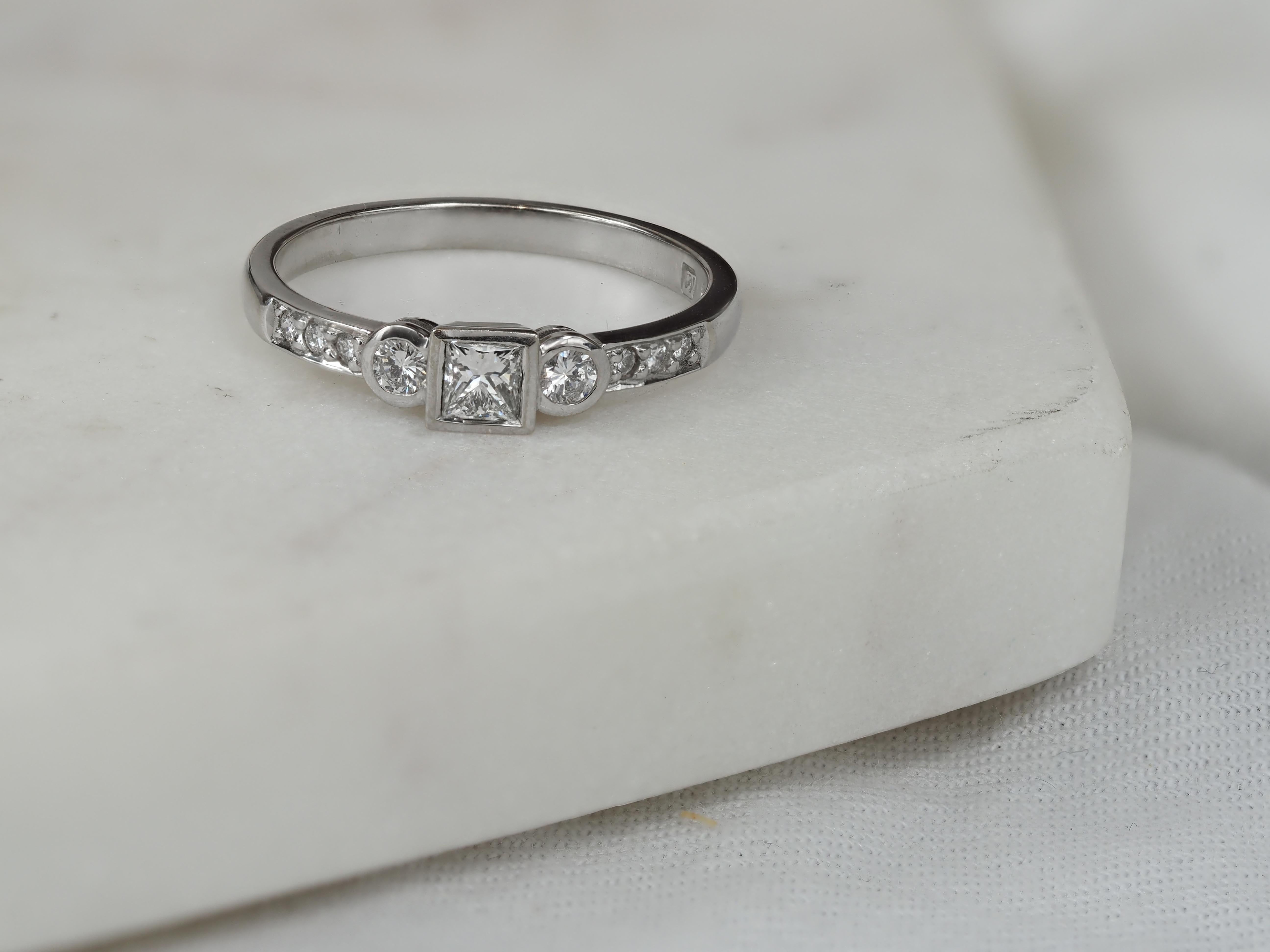18ct White Gold Princess and Round Brillant cut Diamond Engagement Ring