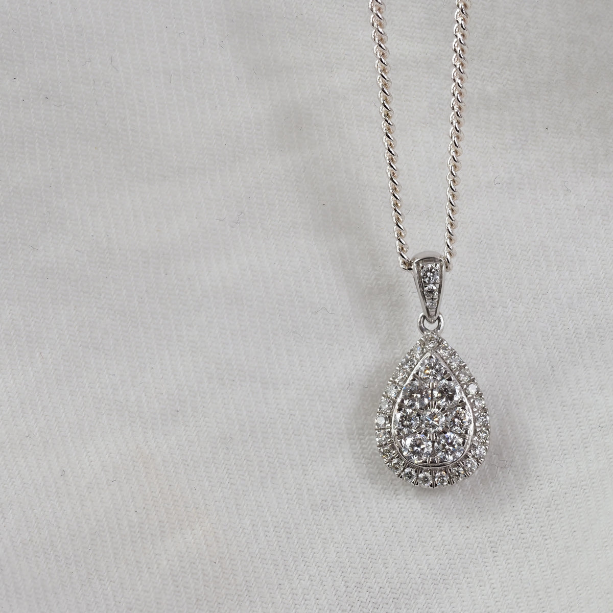 9ct White Gold Pear Shaped cluster Diamond pendant, equaling 0.52ct