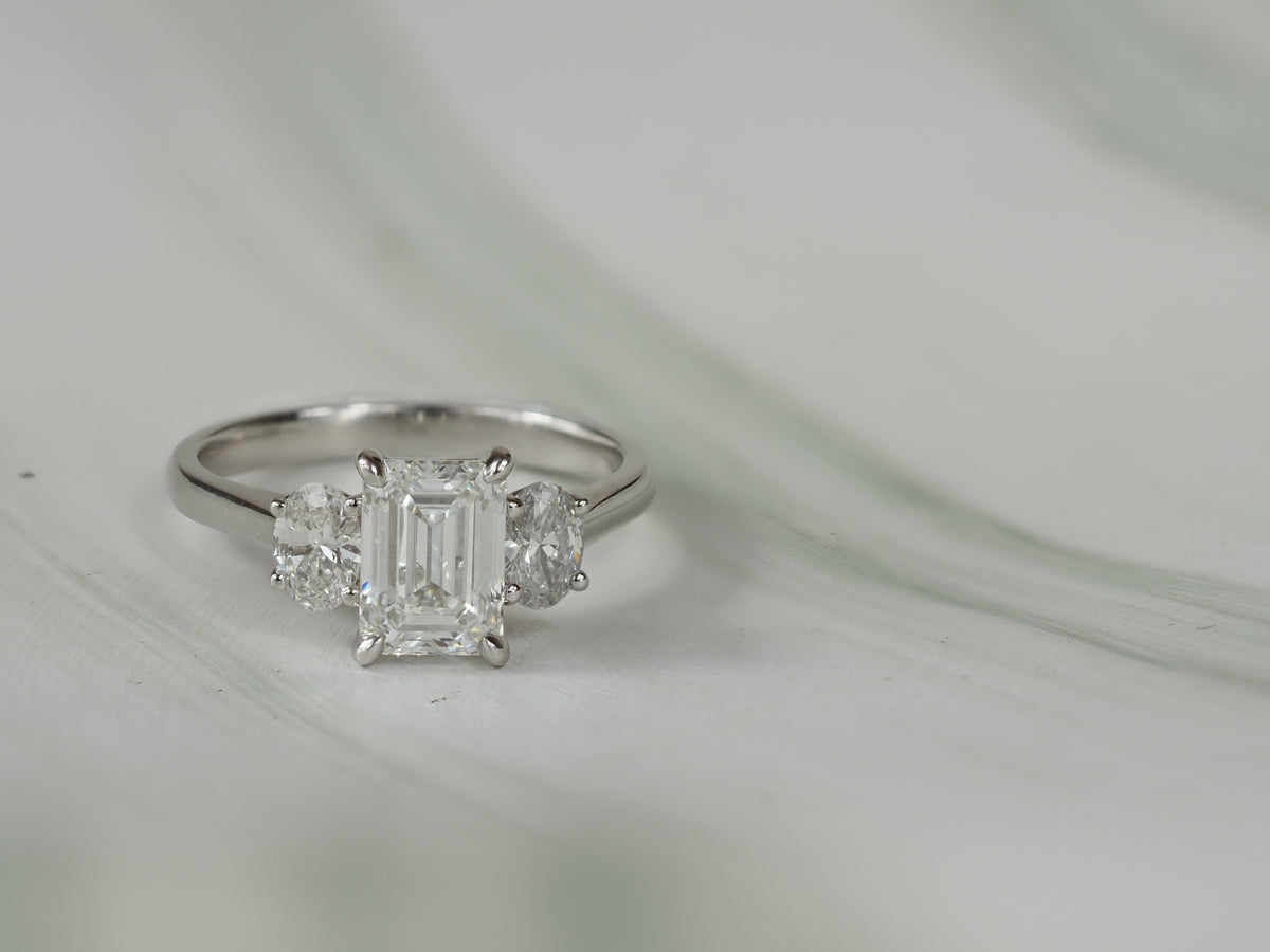 18ct White Gold Lab-Grown Emerald & Oval Trilogy Diamond Engagement Ring, 2.08ct total