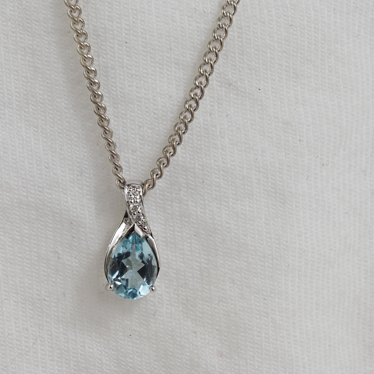 9ct White Gold Blue Topaz and Diamond pendant