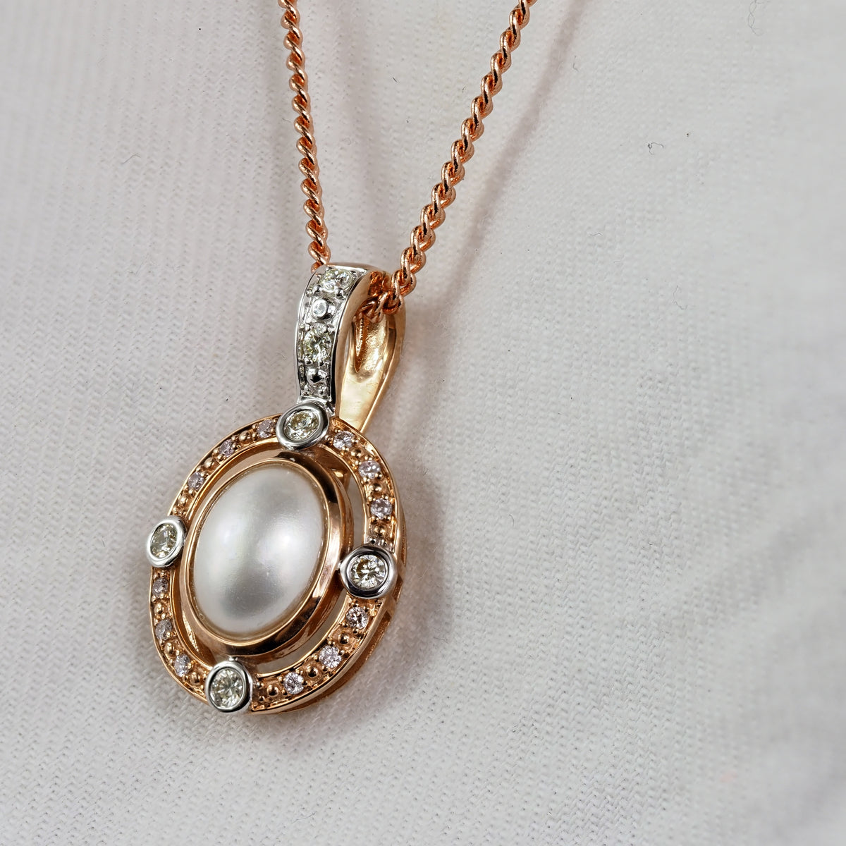 9ct Rose and White 'Pink Caviar' Argyle Diamond and Mabe Pearl enhancer, 0.24cts total.