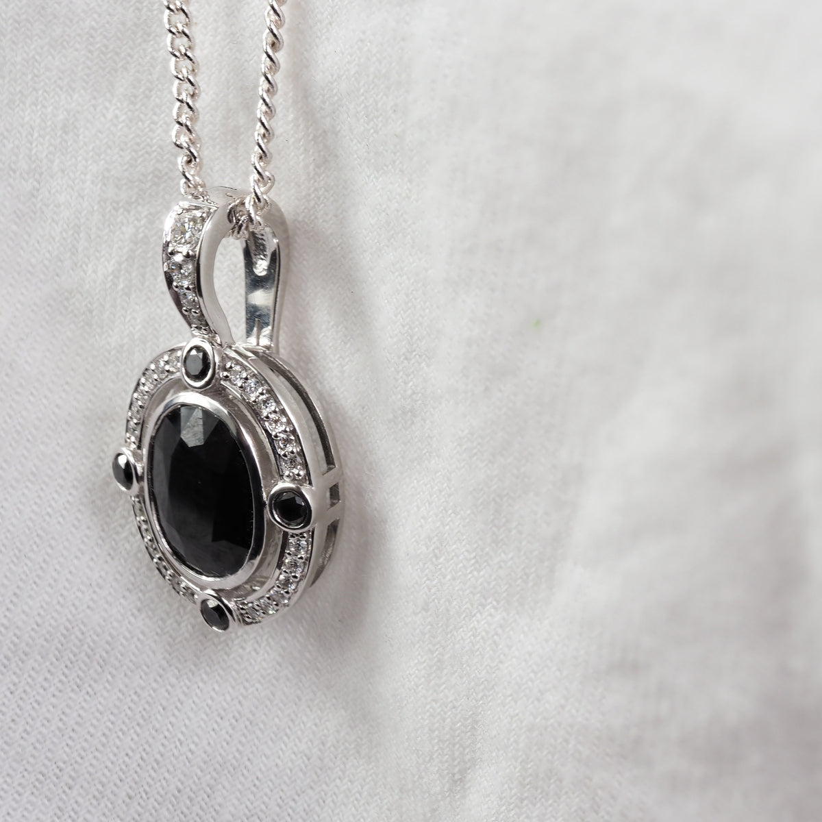 9ct White Gold Sapphire, Diamond and Black Diamond pendant